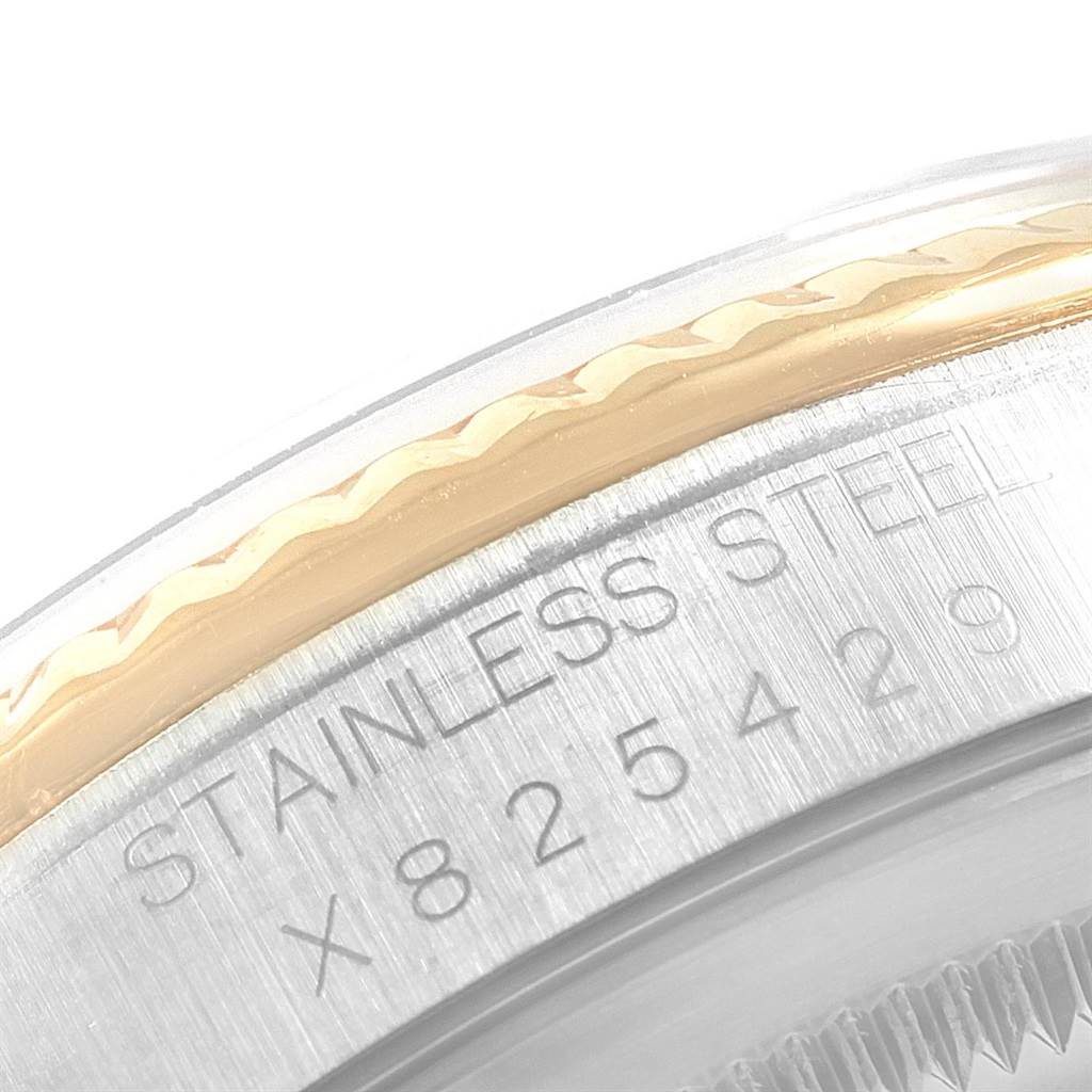 This close-up image shows the bezel and case side of the Rolex Datejust 16233 Men
s Steel and Gold (two tone) Champagne Dial 16233 Men
s Steel and Gold (two tone) Champagne Dial model, including part of the engraved reference number.