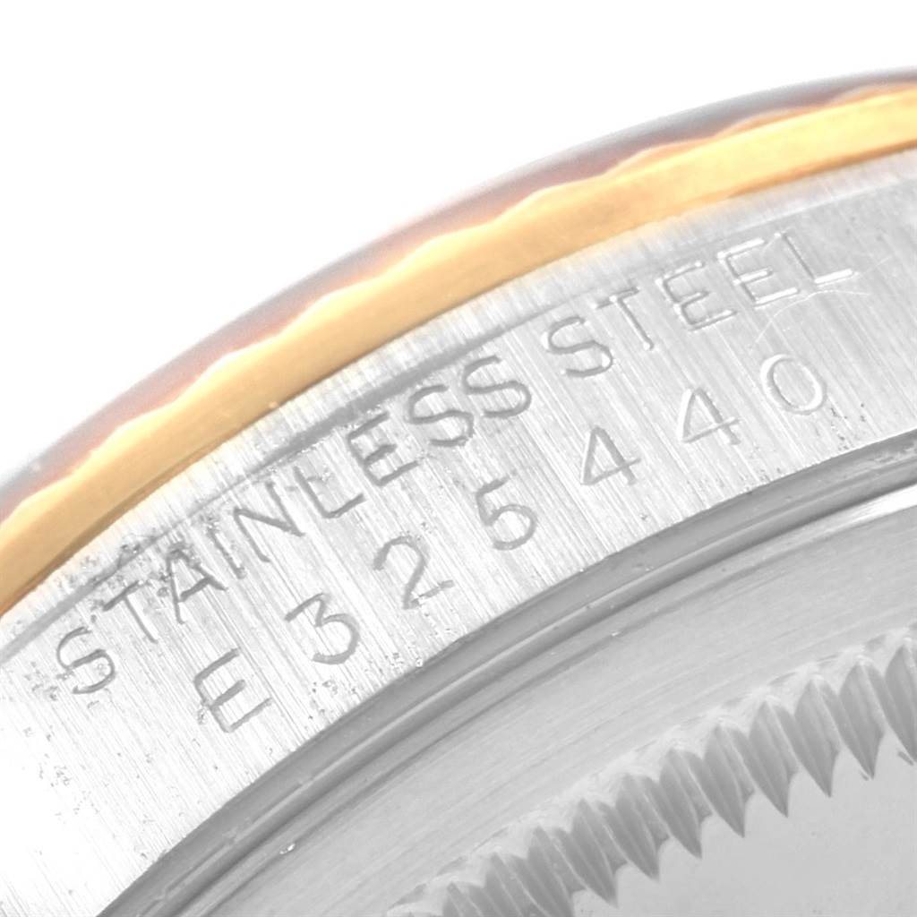The image shows a close-up view of the stainless steel case and serial number of a Rolex Datejust 16233 Men's Steel and Gold (two tone) Black Dial 16233 Men's Steel and Gold (two tone) Black Dial watch.
