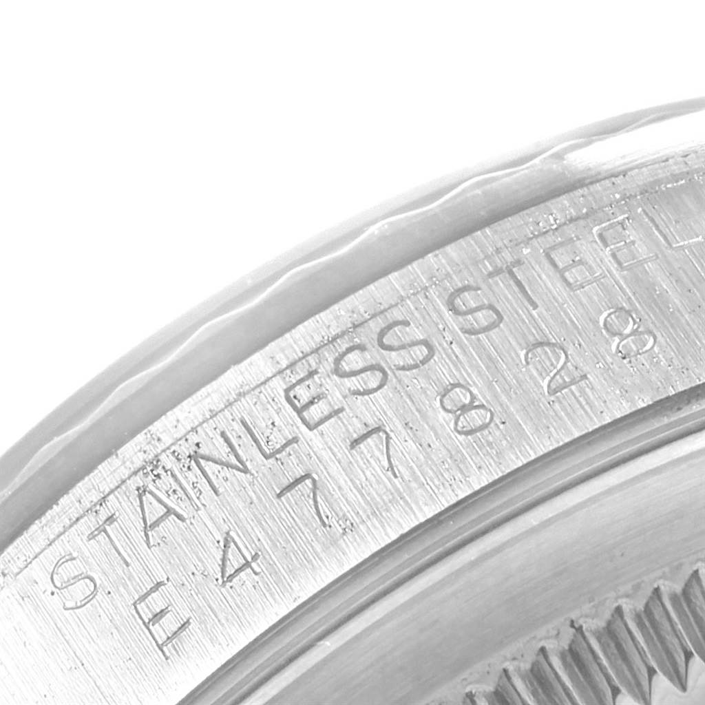 This close-up image shows the engraved inner bezel and case of a Rolex Datejust 16234 Men's Stainless Steel Silver Dial 16234 Men's Stainless Steel Silver Dial watch.