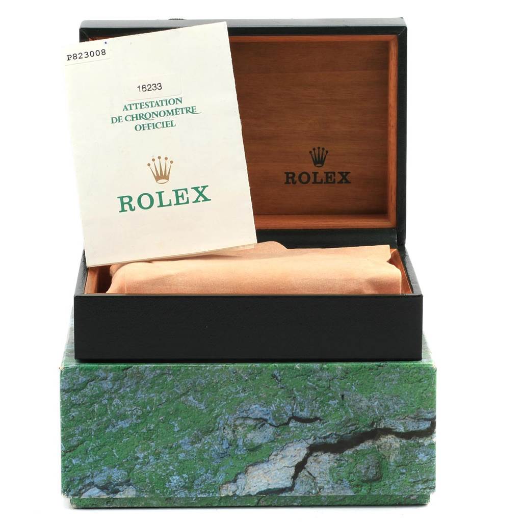 This image shows a Rolex Datejust 16233 Men
s Steel and Gold (two tone) Blue Dial 16233 Men
s Steel and Gold (two tone) Blue Dial box open with an official certificate resting on the cushion inside.