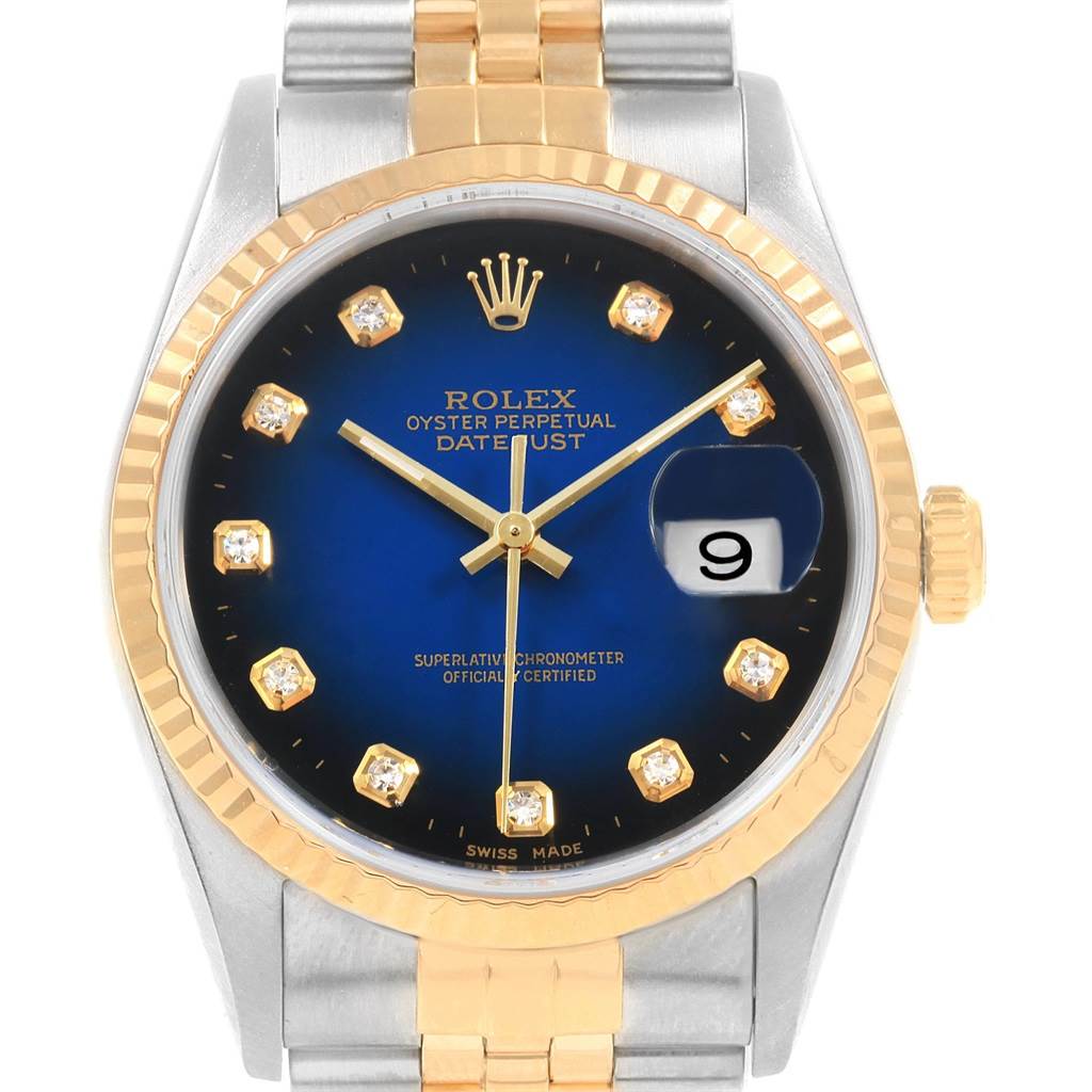 The image shows a front view of a Rolex Datejust 16233 Men
s Steel and Gold (two tone) Blue Dial 16233 Men
s Steel and Gold (two tone) Blue Dial watch, featuring a gold and silver bracelet and a blue diamond-encrusted dial.