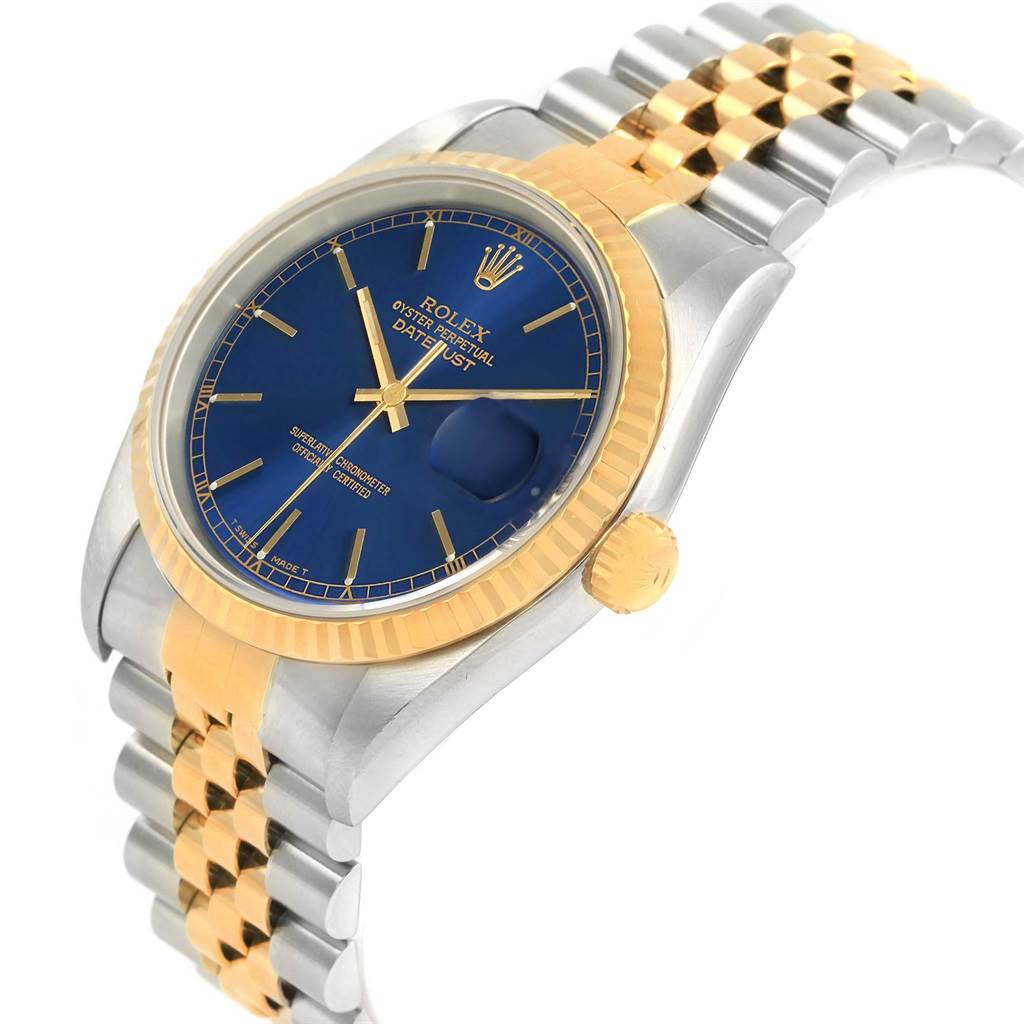 The Rolex Datejust 16233 Men's Steel and Gold (two tone) Blue Dial 16233 Men's Steel and Gold (two tone) Blue Dial watch is shown at an angled view, highlighting its blue dial, gold fluted bezel, and two-tone bracelet.