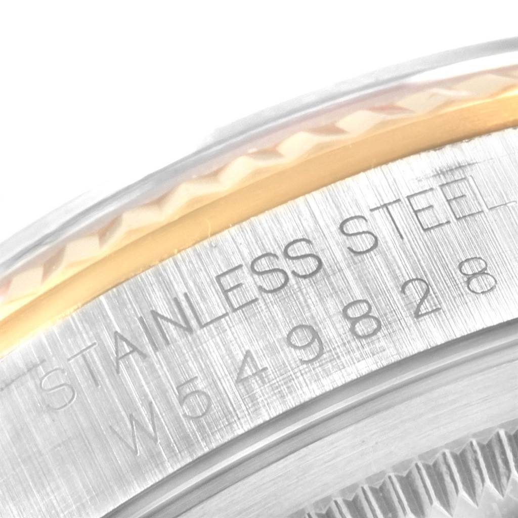 This image shows a close-up of the case back and bezel of a Rolex Datejust 16233 Men's Steel and Gold (two tone) Blue Dial 16233 Men's Steel and Gold (two tone) Blue Dial watch, highlighting the "Stainless Steel" engraving.