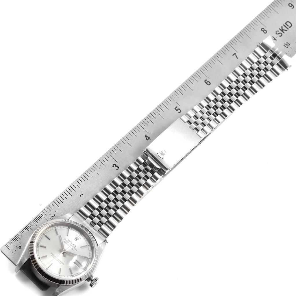 The image shows a Rolex Datejust 16234 Men's Stainless Steel Silver Dial 16234 Men's Stainless Steel Silver Dial watch laid flat alongside a ruler, displaying its face, bezel, and bracelet.