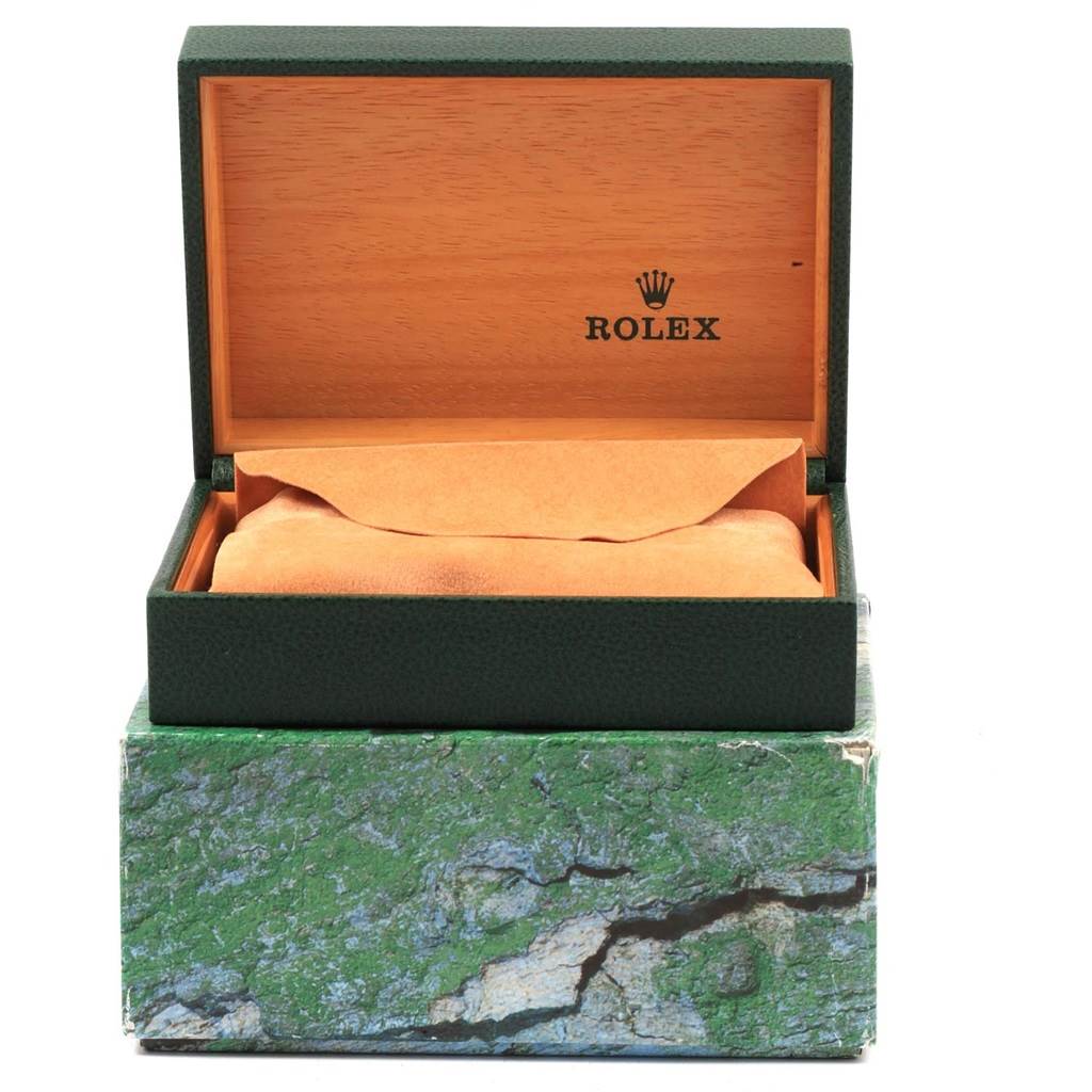 The image shows an open green Rolex box with a tan watch cushion, for a Datejust model.