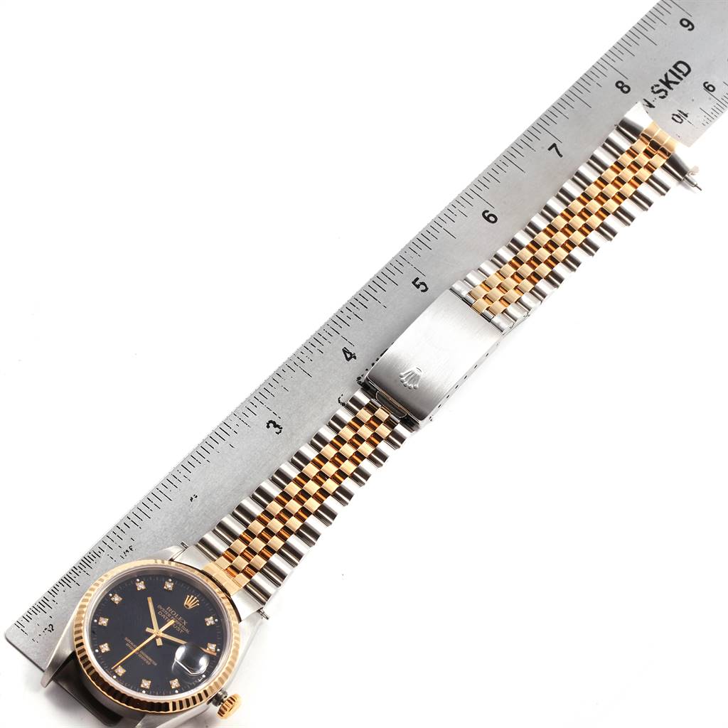 The Rolex Datejust 16233 Men's Steel and Gold (two tone) Black Dial 16233 Men's Steel and Gold (two tone) Black Dial watch is shown from a top-down angle, highlighting its face, bracelet, and clasp.