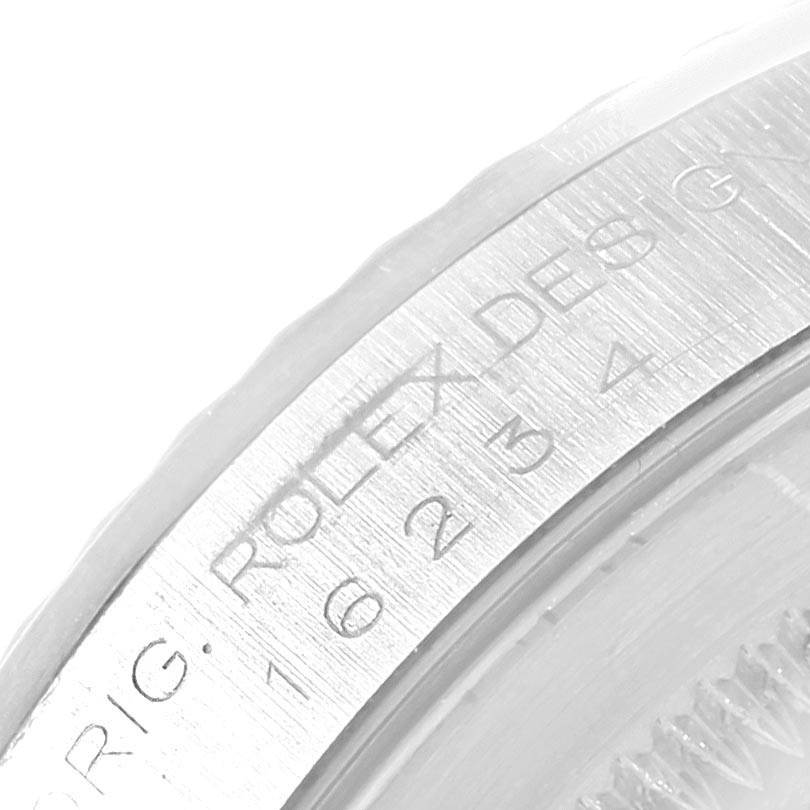 This image shows a close-up of the engraved edge and part of the bezel of a Rolex Datejust 16234 Men's Stainless Steel Silver Dial 16234 Men's Stainless Steel Silver Dial watch.