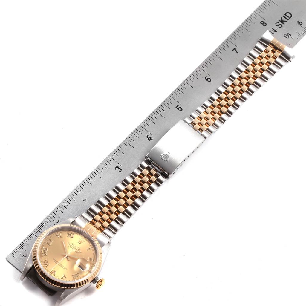 The Rolex Datejust 16233 Men's Steel and Gold (two tone) Champagne Dial 16233 Men's Steel and Gold (two tone) Champagne Dial watch is shown from the top view, displaying the face, bezel, bracelet, and clasp along with a ruler for scale.