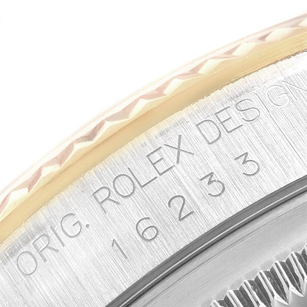 The image shows a close-up angle of the bezel and engraved casing of a Rolex Datejust 16233 Men's Steel and Gold (two tone) Champagne Dial 16233 Men's Steel and Gold (two tone) Champagne Dial watch.