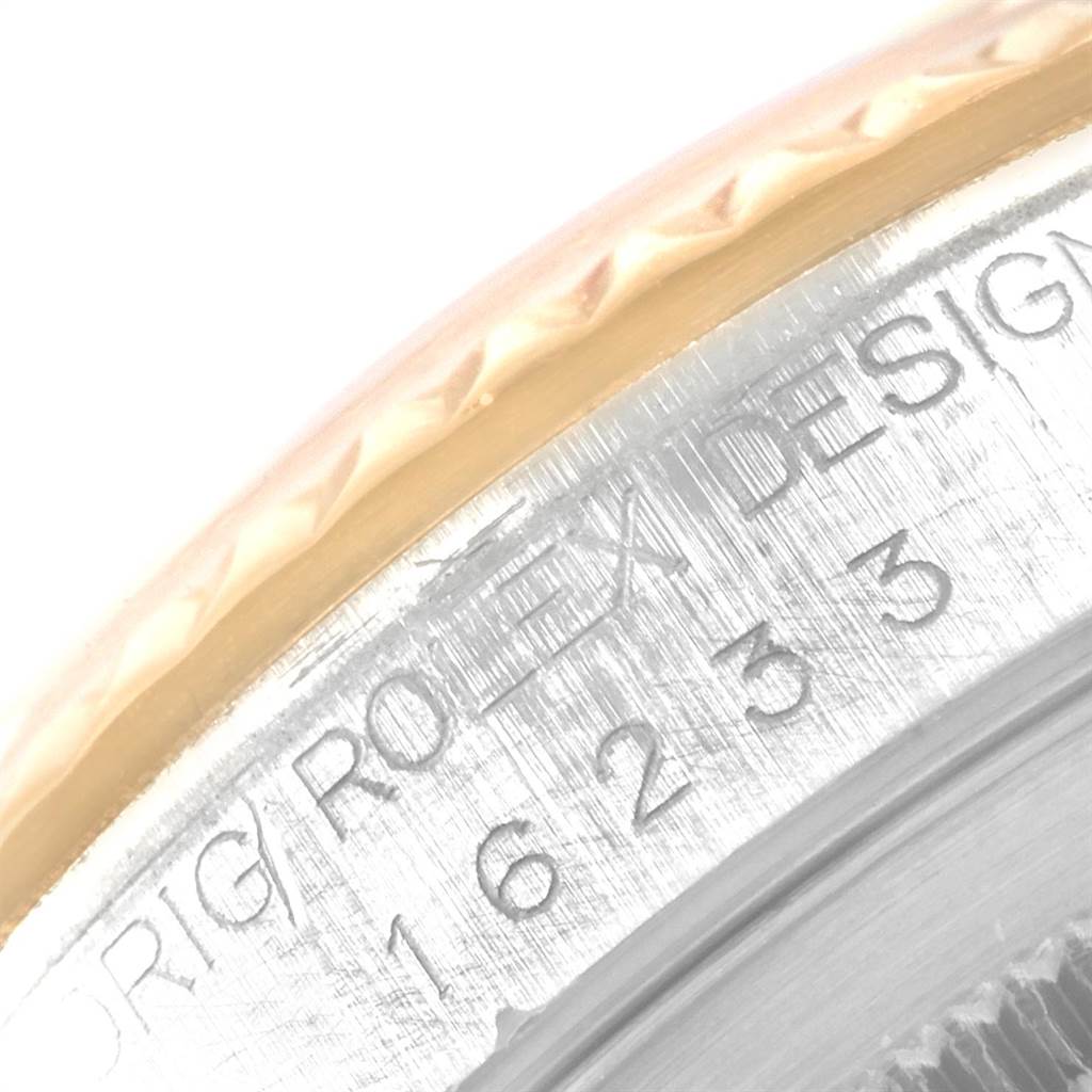 This close-up image shows the engraved bezel and model number of a Rolex Datejust 16233 Men's Steel and Gold (two tone) White Dial 16233 Men's Steel and Gold (two tone) White Dial watch.