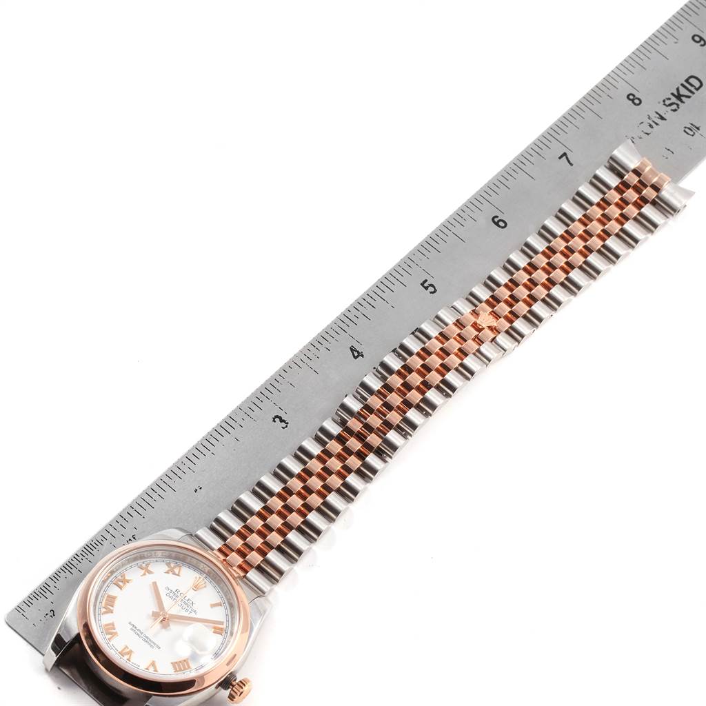 This image shows a Rolex Datejust 116201 Men's Steel and Gold (two tone) White Dial 116201 Men's Steel and Gold (two tone) White Dial watch laid flat with its face and bracelet next to a ruler for measurement.