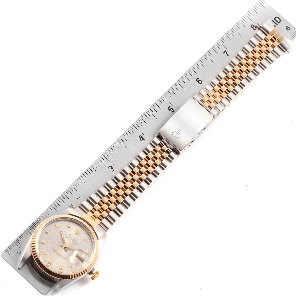 The image shows a Rolex Datejust 16013 Men's Stainless Steel Silver Dial 16013 Men's Stainless Steel Silver Dial watch from a top-down angle, highlighting its face, bezel, bracelet, and clasp next to a ruler.