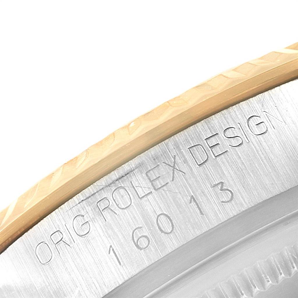 This close-up angle shows the bevel and the engraved design serial number of a Rolex Datejust 16013 Men's Stainless Steel Silver Dial 16013 Men's Stainless Steel Silver Dial model watch.