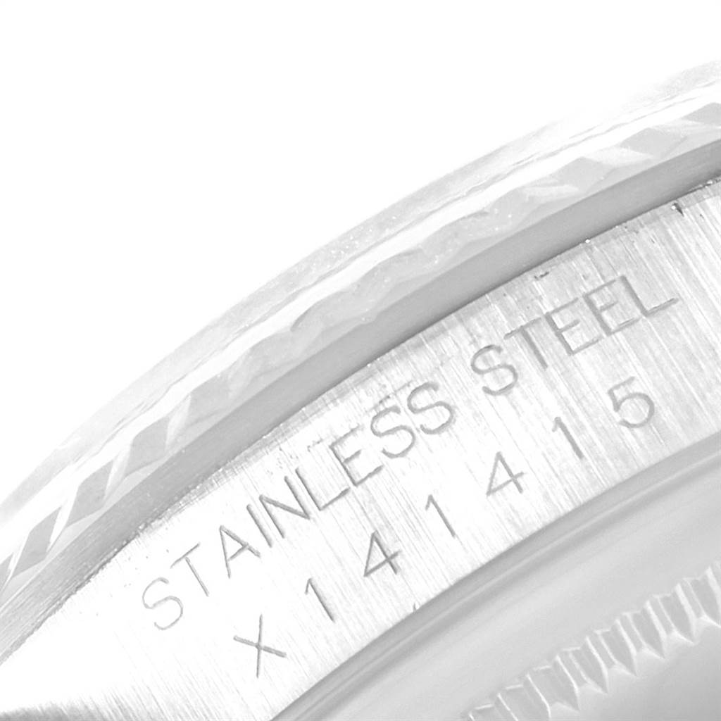 This image shows a close-up of the stainless steel bezel and the serial number of a Rolex Datejust 16234 Men's Stainless Steel Silver Dial 16234 Men's Stainless Steel Silver Dial watch.