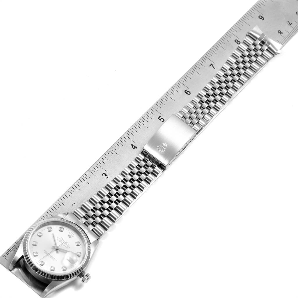 This image shows a Rolex Datejust 16234 Men's Stainless Steel Silver Dial 16234 Men's Stainless Steel Silver Dial watch, including its face, bezel, and bracelet, next to a ruler for scale.