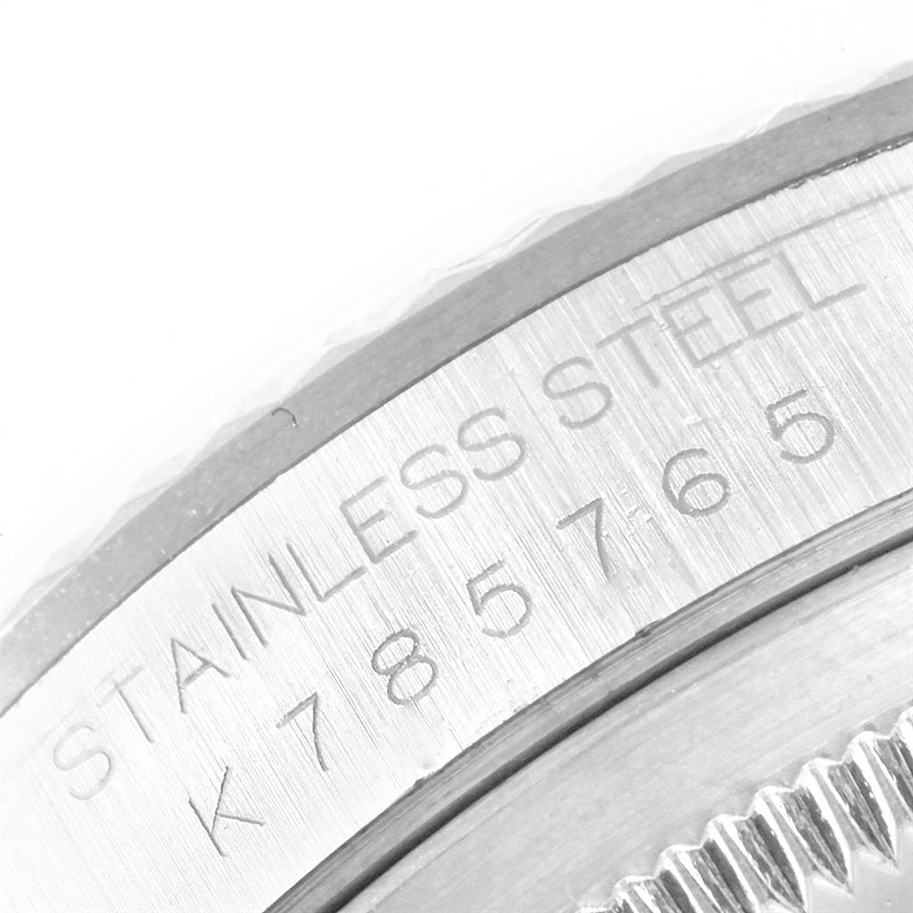 This close-up shows the serial and material inscription on the caseback edge of a Rolex Datejust 16234 Men's Stainless Steel Silver Dial 16234 Men's Stainless Steel Silver Dial watch.
