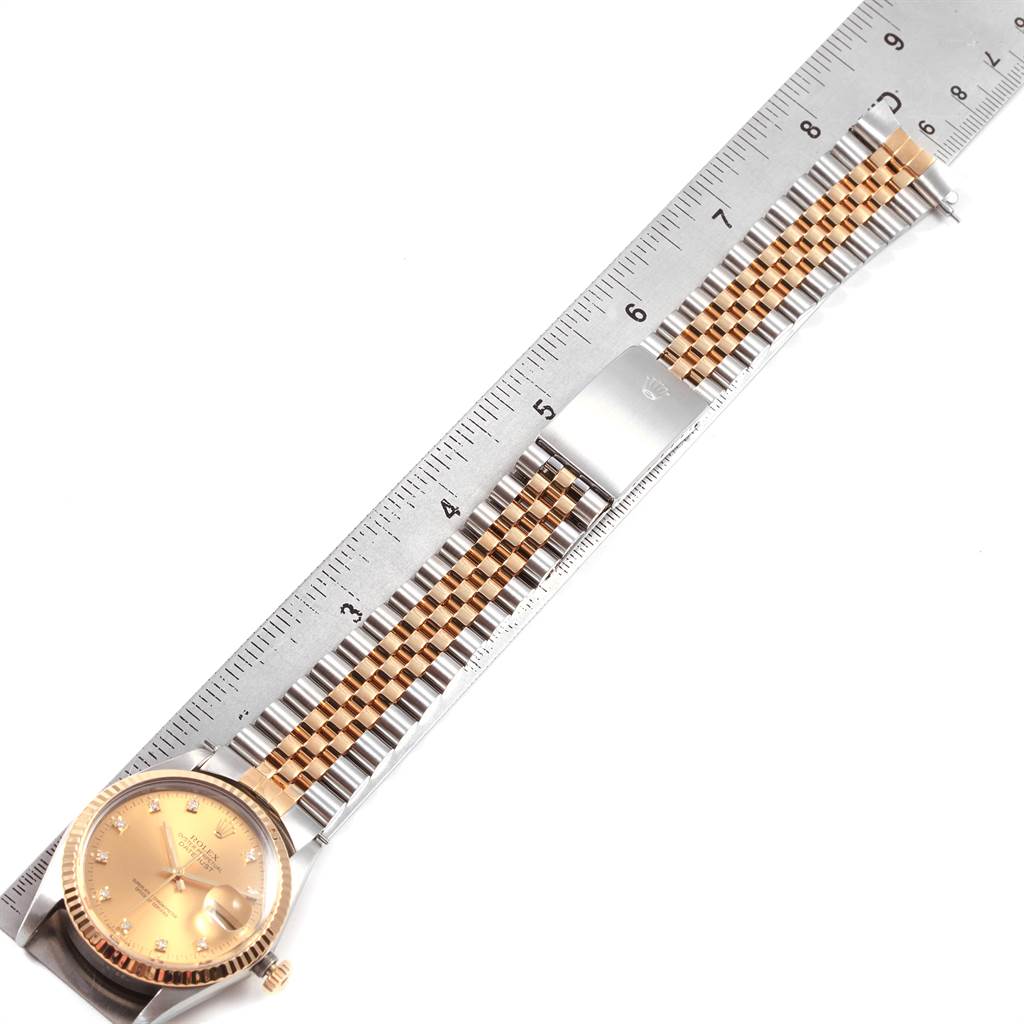 The image shows a Rolex Datejust 16013 Men's Stainless Steel Champagne Dial 16013 Men's Stainless Steel Champagne Dial watch laid flat with a ruler measuring the length of its jubilee bracelet.