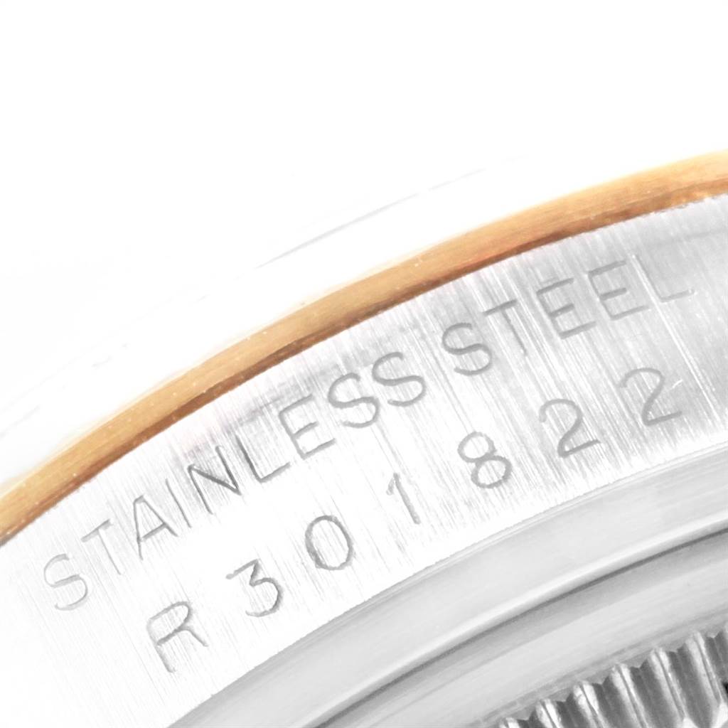 This close-up image of the Rolex Datejust 16013 Men's Stainless Steel Champagne Dial 16013 Men's Stainless Steel Champagne Dial watch shows the stainless steel case and part of the model number engraving.