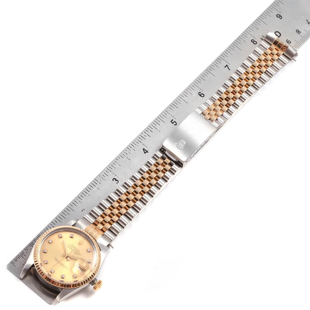 The image shows a Rolex Datejust 16013 Men's Stainless Steel Champagne Dial 16013 Men's Stainless Steel Champagne Dial watch laid flat next to a ruler, highlighting the dial, strap, and clasp.