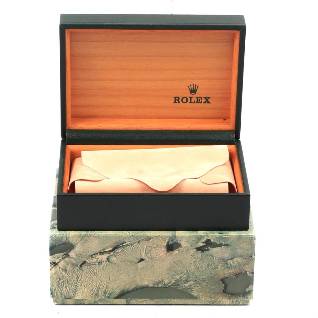 The image shows an open Rolex box, revealing the packaging for a Datejust model watch inside.