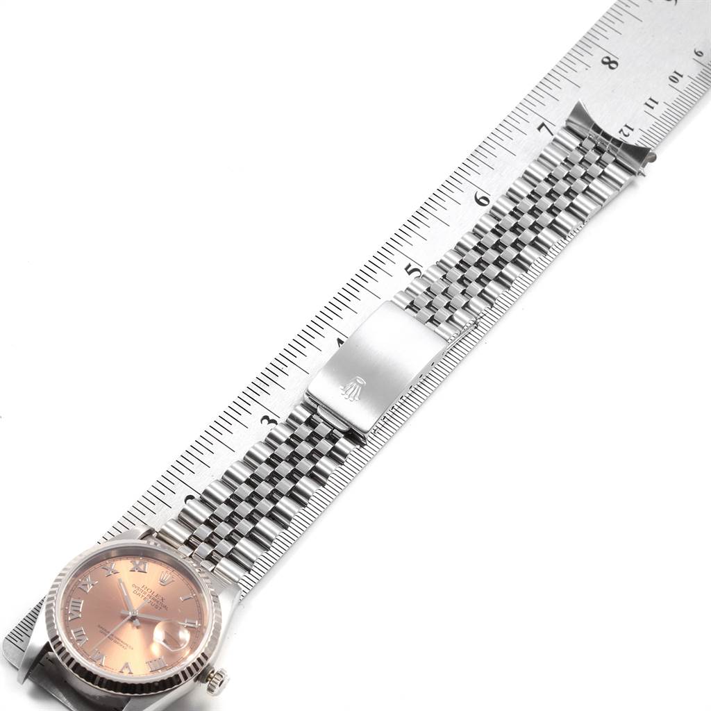 The image shows a Rolex Datejust 16234 Men's Stainless Steel Pink Dial 16234 Men's Stainless Steel Pink Dial watch from a top-down angle, highlighting the dial, fluted bezel, bracelet, and clasp.