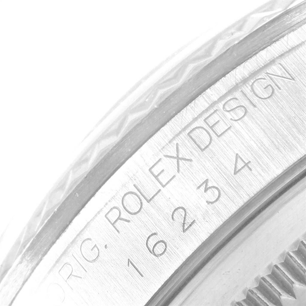 This close-up angle shows the edge of the bezel and the model number engraving of the Rolex Datejust 16234 Men's Stainless Steel Pink Dial 16234 Men's Stainless Steel Pink Dial watch.
