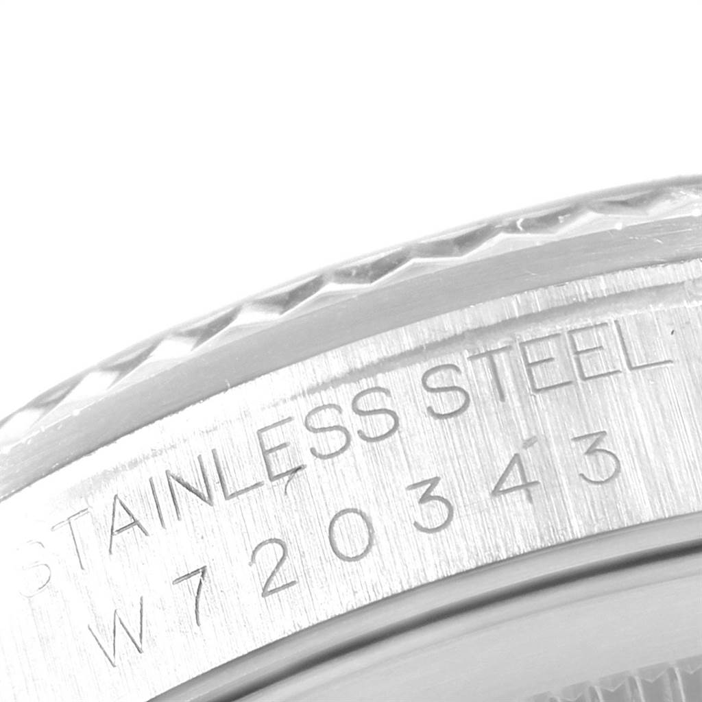 This close-up image shows the engraved serial number and "STAINLESS STEEL" text on the case back of a Rolex Datejust 16234 Men's Stainless Steel Pink Dial 16234 Men's Stainless Steel Pink Dial watch.