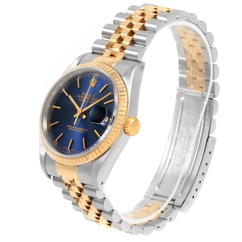 The Rolex Datejust 16233 Men's Steel and Gold (two tone) Blue Dial 16233 Men's Steel and Gold (two tone) Blue Dial watch is shown from a left-front angle, highlighting its blue dial, gold bezel, and two-tone bracelet.