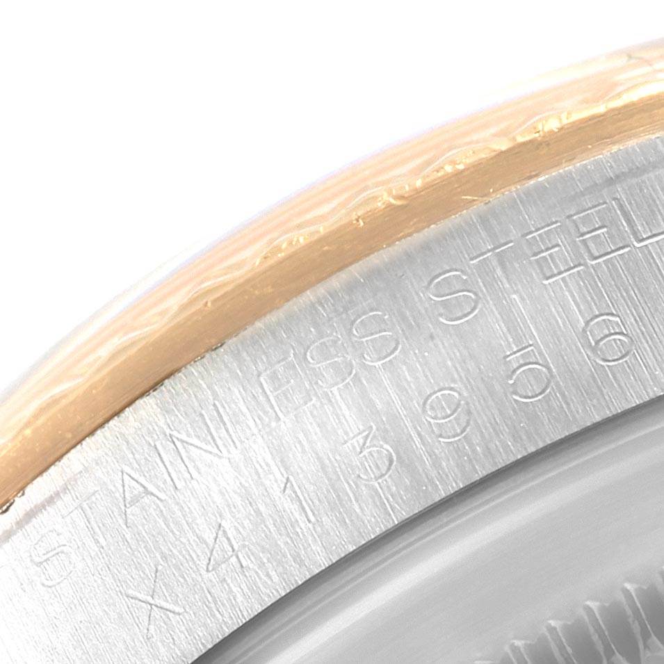 The image shows a close-up angle of the edge and engraving on the case back of a Rolex Datejust 16233 Men's Steel and Gold (two tone) Blue Dial 16233 Men's Steel and Gold (two tone) Blue Dial watch.