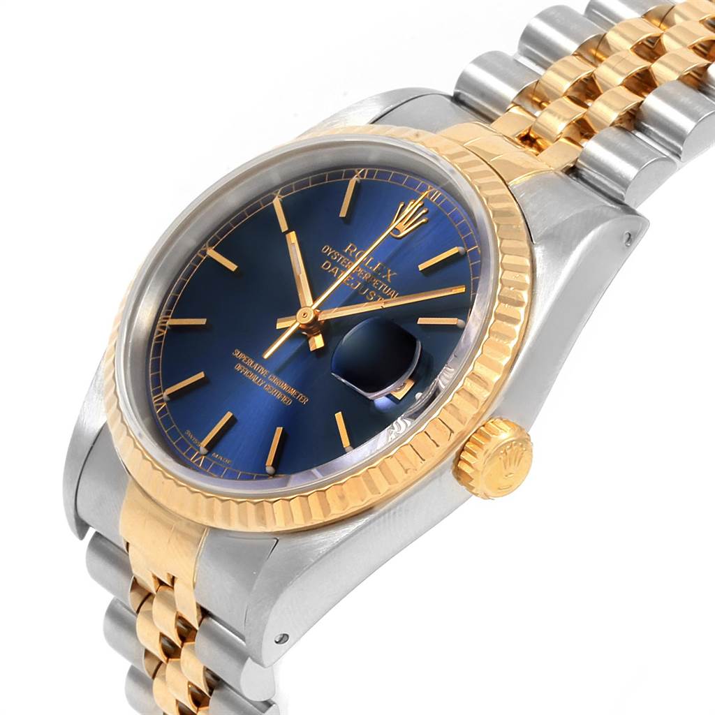 The Rolex Datejust 16233 Men's Steel and Gold (two tone) Blue Dial 16233 Men's Steel and Gold (two tone) Blue Dial model watch is shown at a three-quarter angle featuring a blue dial, gold fluted bezel, and two-tone bracelet.