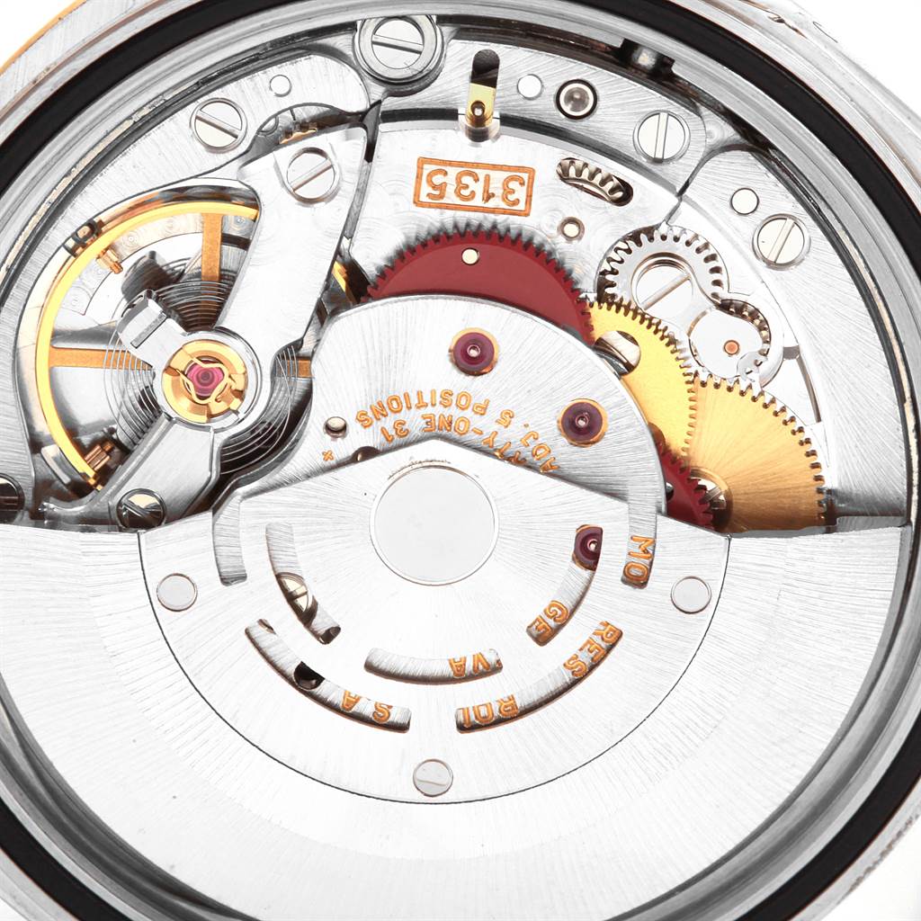 Close-up of the mechanical movement of a Rolex Datejust 16233 Men's Steel and Gold (two tone) Blue Dial 16233 Men's Steel and Gold (two tone) Blue Dial, showcasing its intricate gears and components.