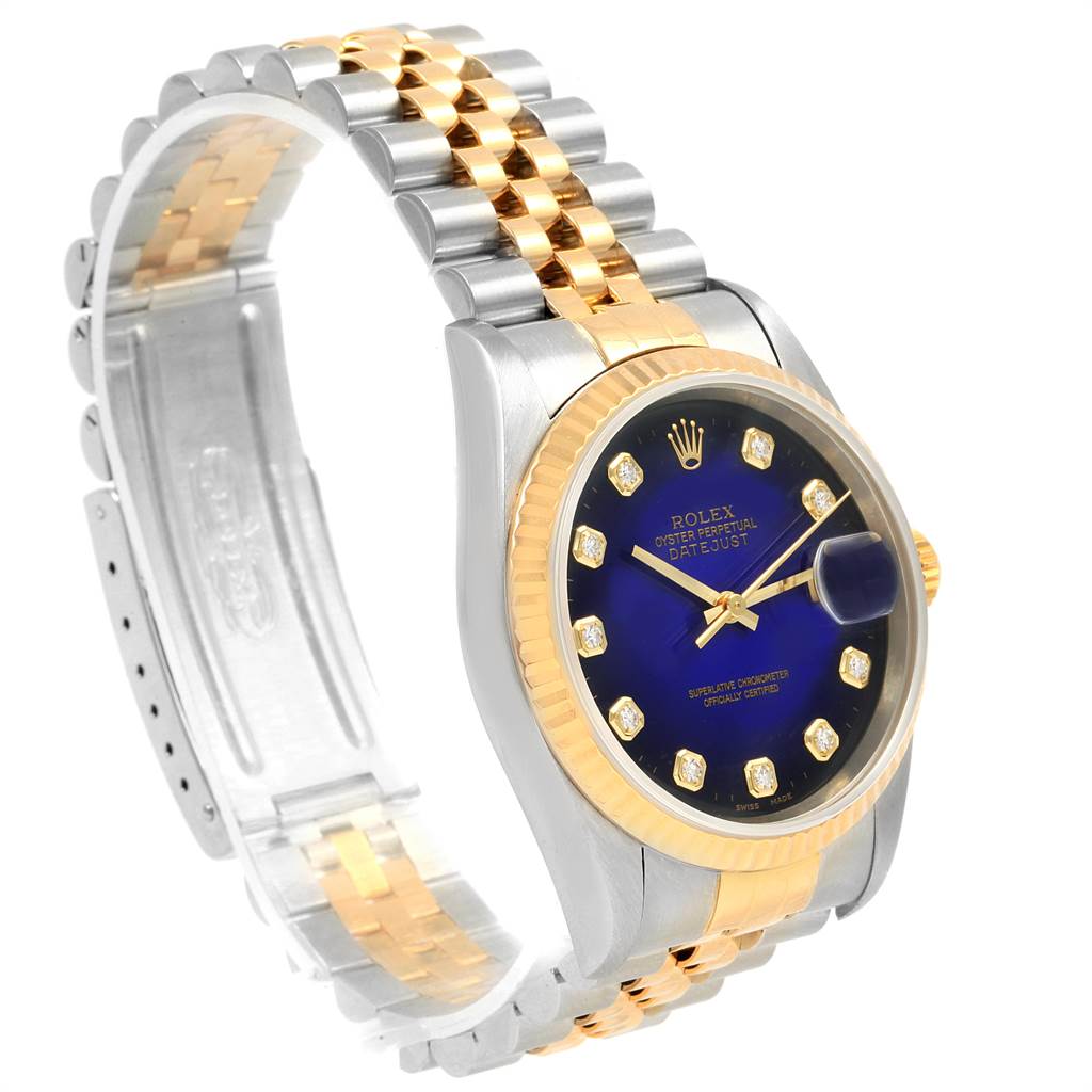 The image shows a side-angle view of a Rolex Datejust 16233 Men's Steel and Gold (two tone) Blue Dial 16233 Men's Steel and Gold (two tone) Blue Dial watch featuring its two-tone bracelet, blue dial, and date magnifier.