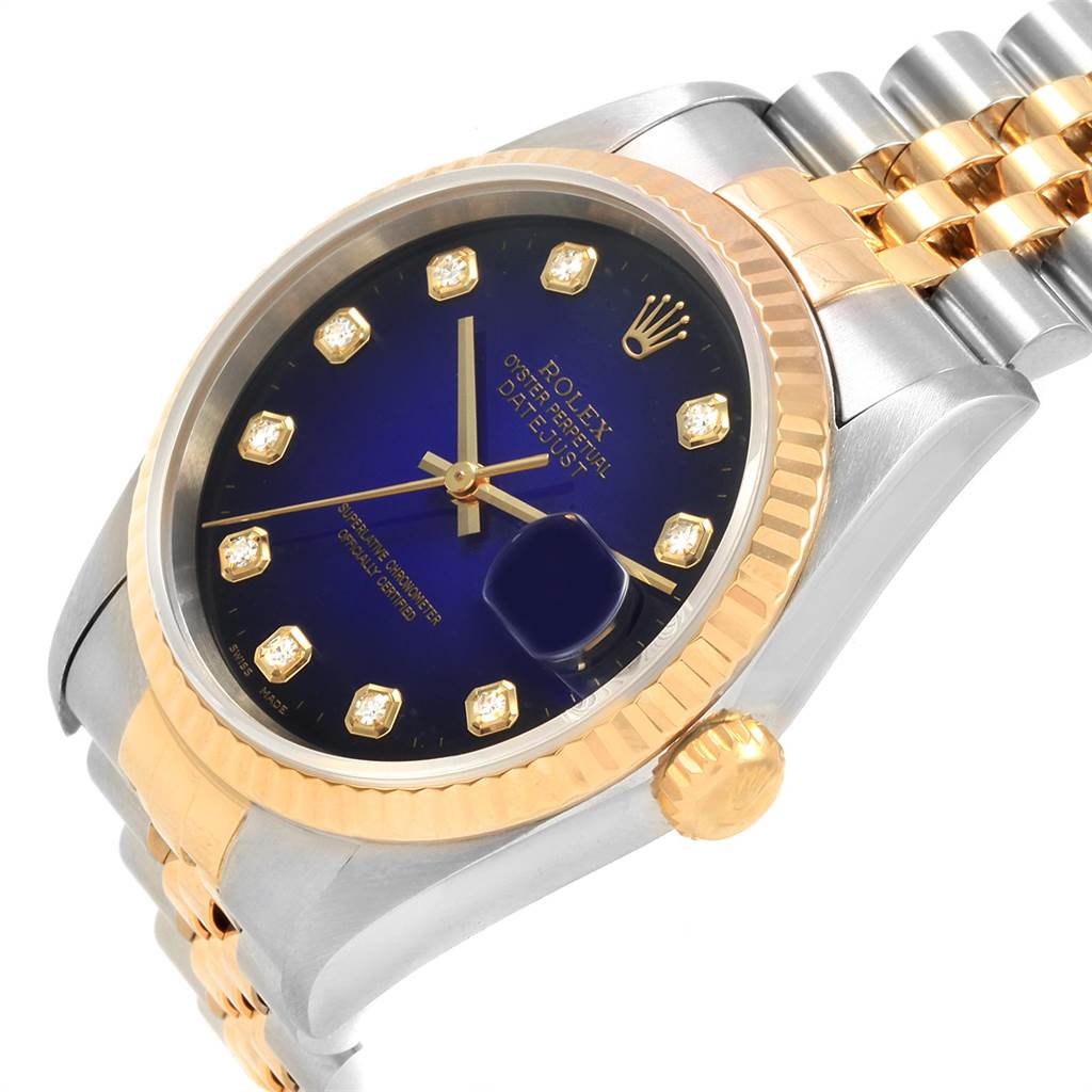 The image shows a close-up angle of the Rolex Datejust 16233 Men's Steel and Gold (two tone) Blue Dial 16233 Men's Steel and Gold (two tone) Blue Dial watch featuring its blue dial, gold bezel, and two-tone bracelet.