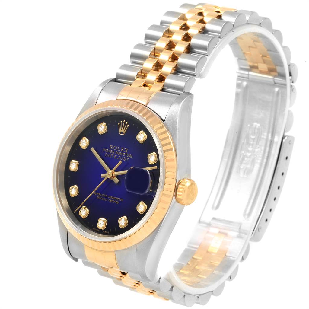 This image shows a Rolex Datejust 16233 Men's Steel and Gold (two tone) Blue Dial 16233 Men's Steel and Gold (two tone) Blue Dial watch at a slight angle, highlighting the dial, fluted bezel, and two-tone bracelet.