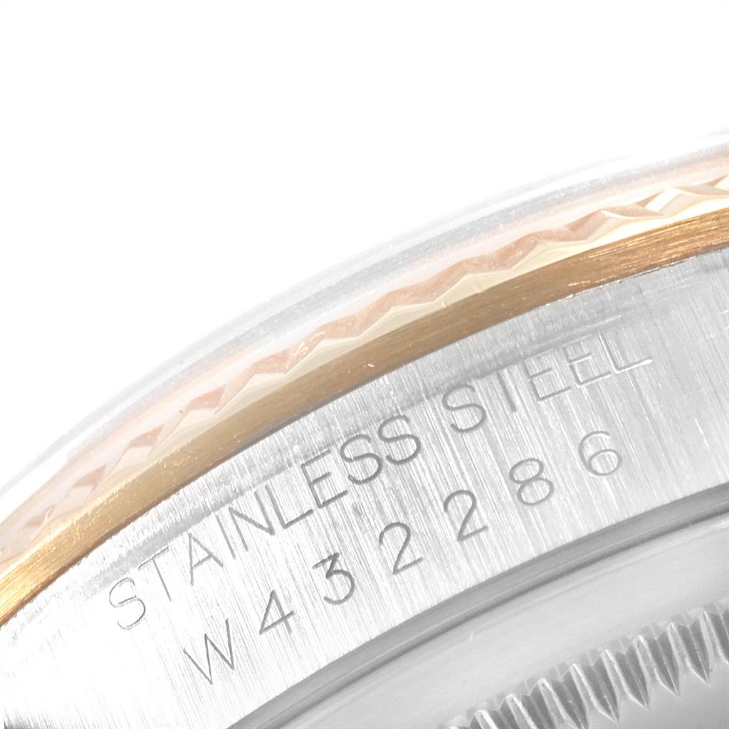 This image shows a close-up of the side of a Rolex Datejust 16233 Men's Steel and Gold (two tone) Blue Dial 16233 Men's Steel and Gold (two tone) Blue Dial model, highlighting the fluted bezel and part of the case with the serial number.