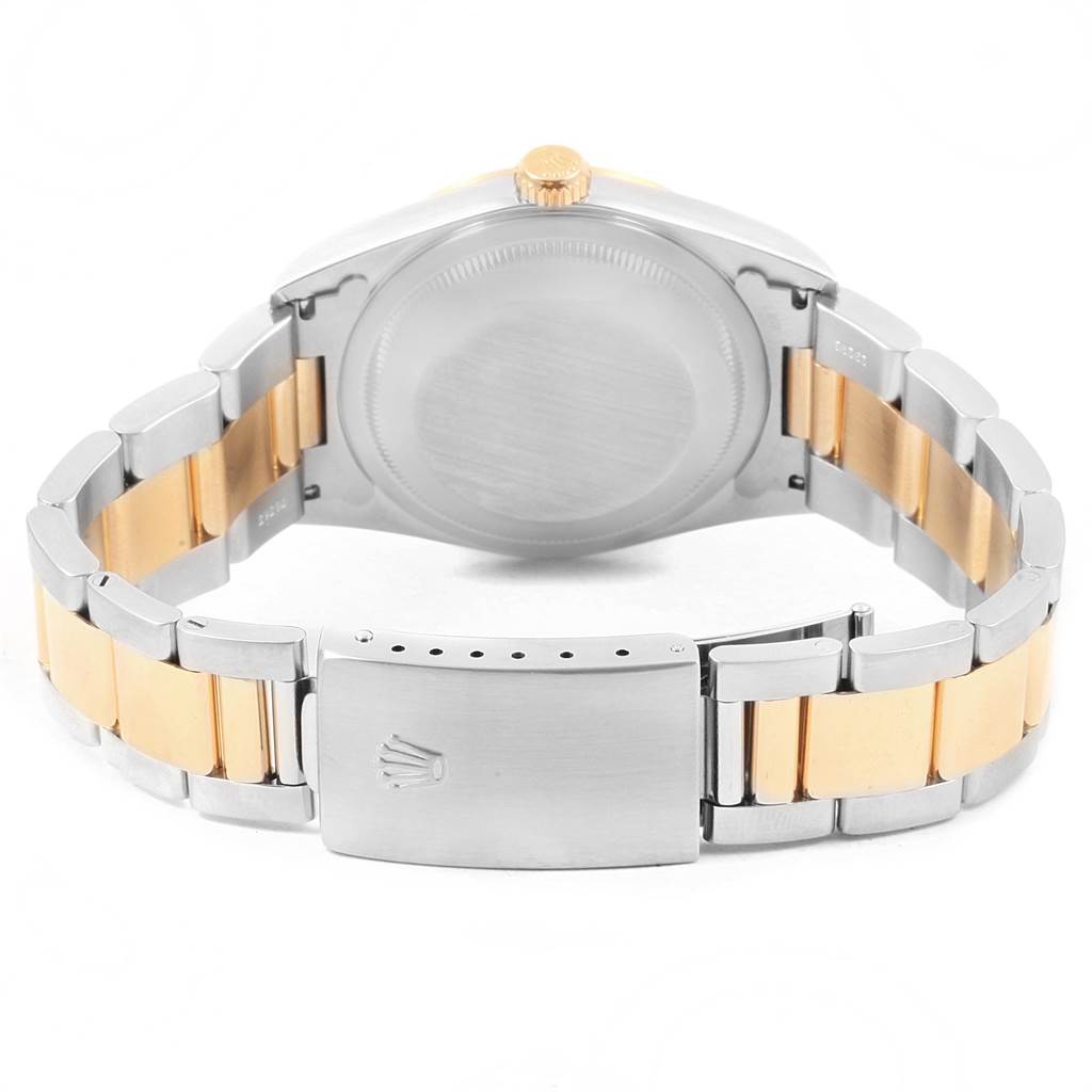 The image shows the back of a Rolex Datejust 16203 Men's Steel and Gold (two tone) Champagne Dial 16203 Men's Steel and Gold (two tone) Champagne Dial watch, highlighting its case, crown, and two-tone bracelet with clasp.