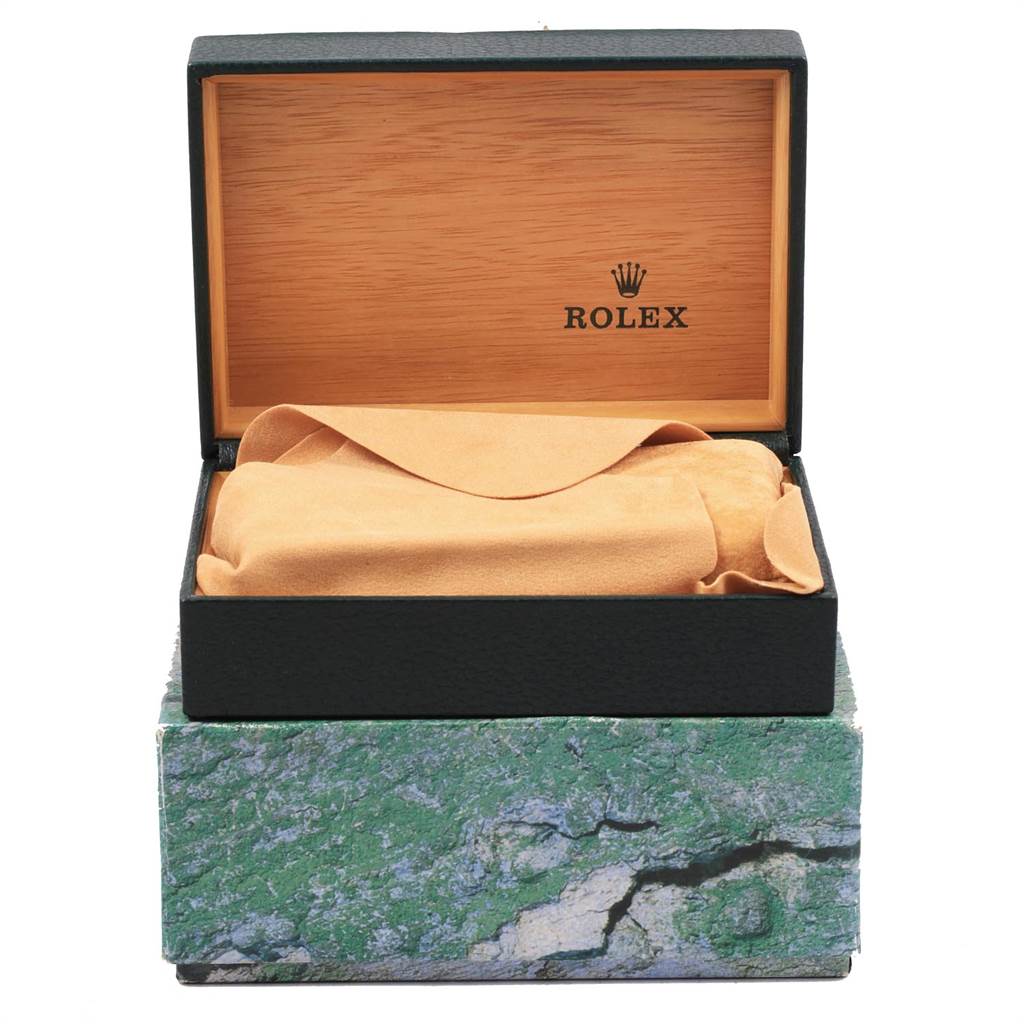 This image shows the packaging of a Rolex Datejust 16203 Men's Steel and Gold (two tone) Champagne Dial 16203 Men's Steel and Gold (two tone) Champagne Dial watch, including an open green textured box and an interior lined in wood and fabric.