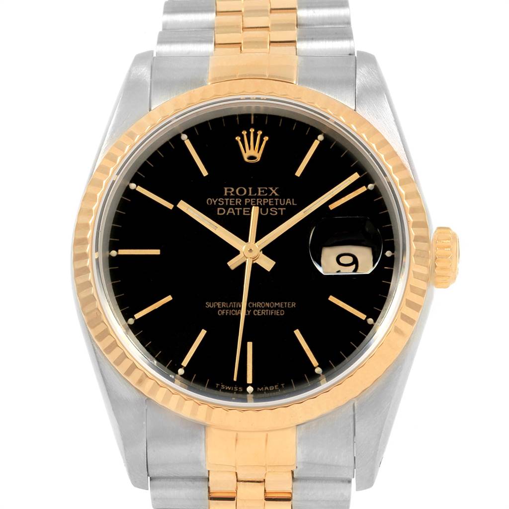 The image shows a front view of the Rolex Datejust 16233 Men's Steel and Gold (two tone) Black Dial 16233 Men's Steel and Gold (two tone) Black Dial watch, highlighting the black dial, gold fluted bezel, and two-tone bracelet.