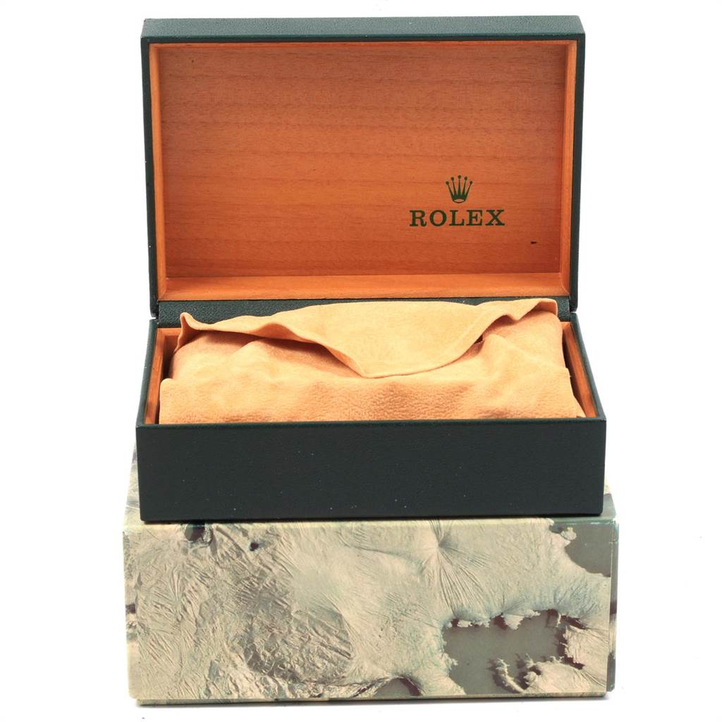 The image shows a Datejust model Rolex watch box, partially open, with a suede pouch inside.