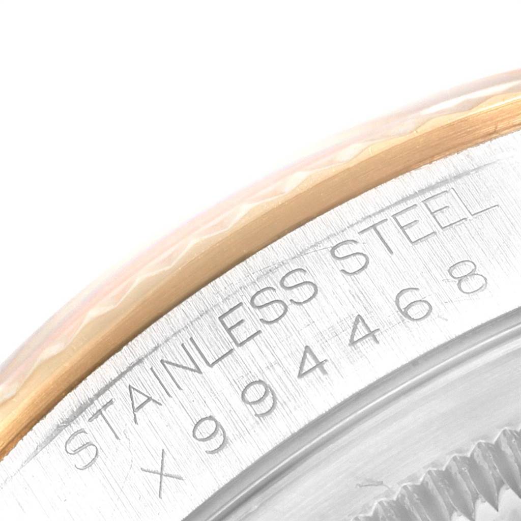 The image shows a close-up of the serial number and stainless steel inscription on the side of a Rolex Datejust 16233 Men's Steel and Gold (two tone) Black Dial 16233 Men's Steel and Gold (two tone) Black Dial watch.
