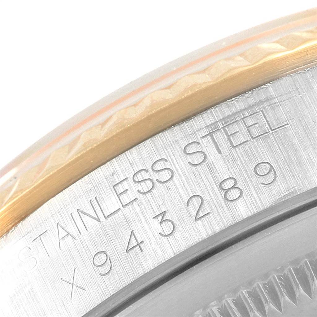 The image shows a close-up of the serial number and "Stainless Steel" engraving on the side of a Rolex Datejust 16233 Men's Steel and Gold (two tone) Black Dial 16233 Men's Steel and Gold (two tone) Black Dial watch case.