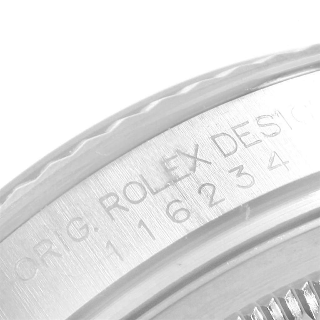 This close-up image shows the engraved case side of a Rolex Datejust 116234 Men's Stainless Steel White Dial 116234 Men's Stainless Steel White Dial watch.