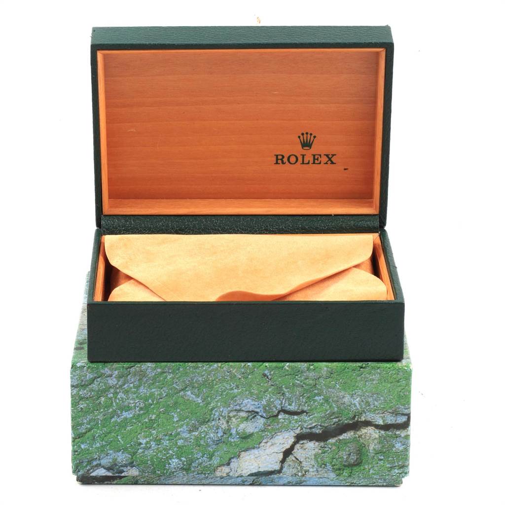 The image shows an open Rolex watch box, with the box tilted slightly forward, revealing the interior cushioning.