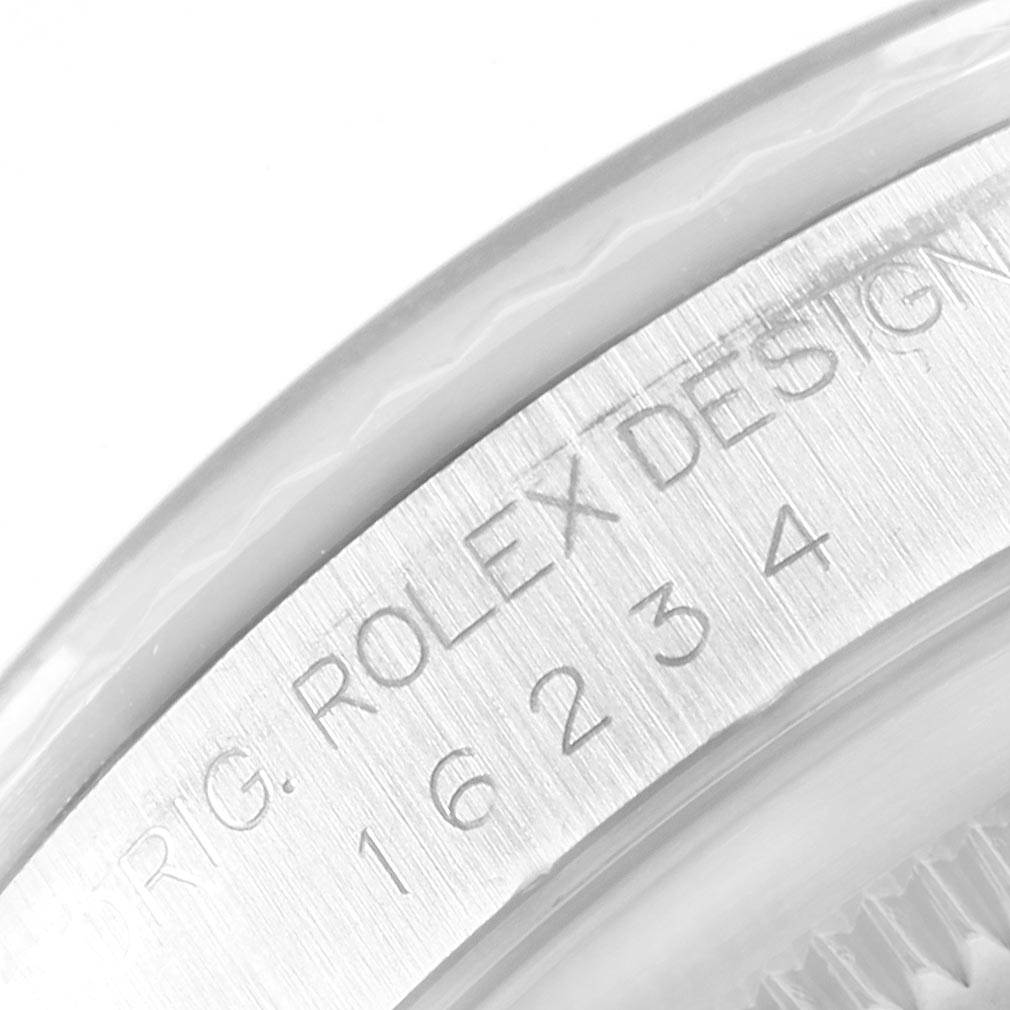 This close-up image shows the engraved serial number and model details on the bezel of a Rolex Datejust 16234 Men
s Stainless Steel Pink Dial 16234 Men
s Stainless Steel Pink Dial watch.