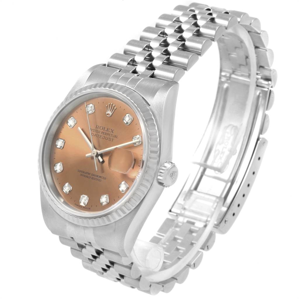 The image shows the Rolex Datejust 16234 Men
s Stainless Steel Pink Dial 16234 Men
s Stainless Steel Pink Dial watch from an angle highlighting its face, bezel, crown, and metal bracelet.