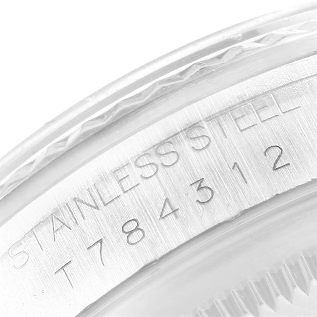 The image shows a close-up of the engraved stainless steel case-back edge of a Rolex Datejust 16234 Men
s Stainless Steel Pink Dial 16234 Men
s Stainless Steel Pink Dial watch.