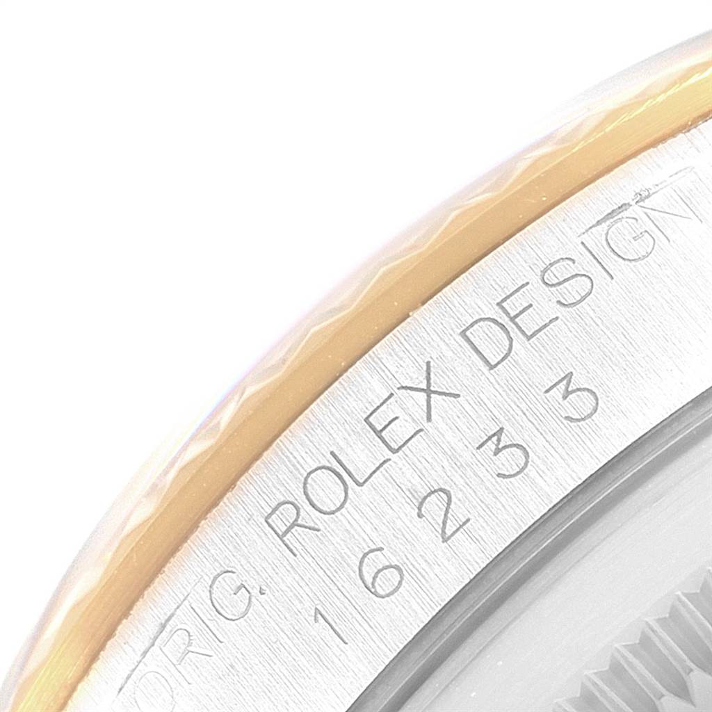 The image shows a close-up view of the outer rim and bezel of a Rolex Datejust 16233 Men
s Steel and Gold (two tone) Silver Dial 16233 Men
s Steel and Gold (two tone) Silver Dial watch, highlighting the engraved text and reference number.
