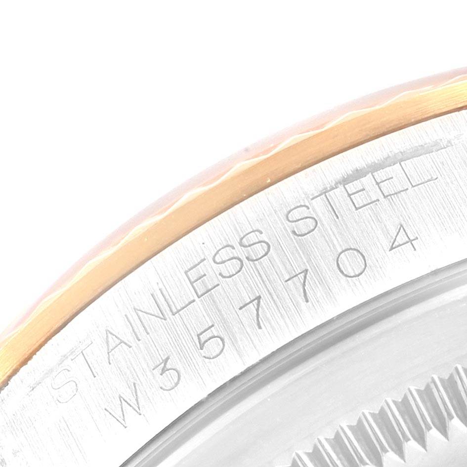 This close-up image of the Rolex Datejust 16233 Men
s Steel and Gold (two tone) Silver Dial 16233 Men
s Steel and Gold (two tone) Silver Dial model shows the engraved stainless steel edge with part of the bezel.