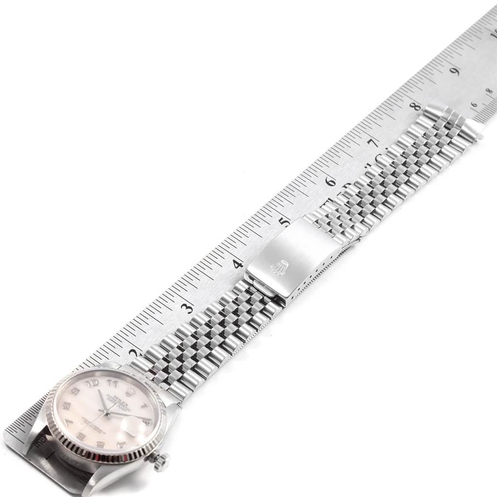 The image shows a Rolex Datejust 16234 Men's Stainless Steel Mother of Pearl Dial 16234 Men's Stainless Steel Mother of Pearl Dial model watch lying flat next to a ruler, displaying its face, bracelet, and clasp.