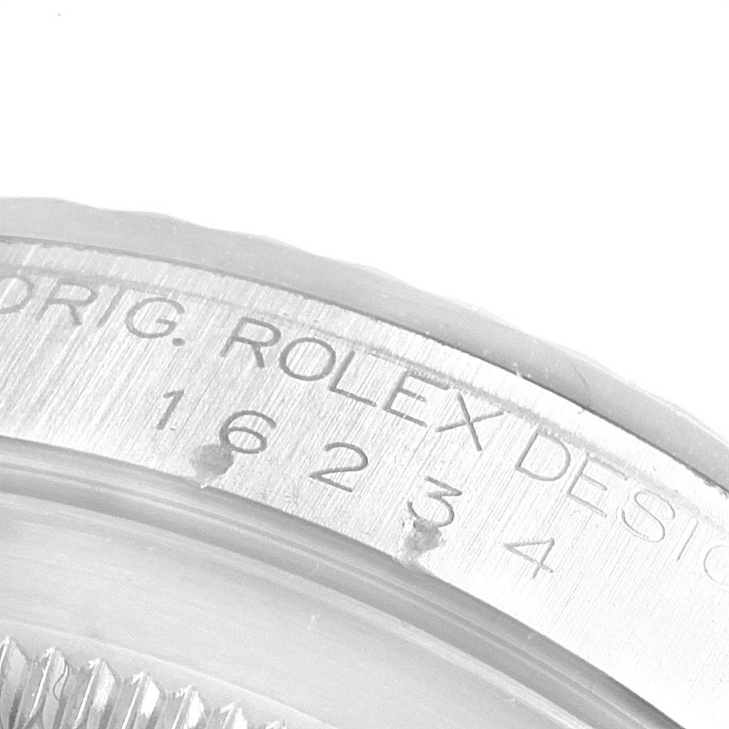 This close-up image shows the engraved bezel of a Rolex Datejust 16234 Men's Stainless Steel Mother of Pearl Dial 16234 Men's Stainless Steel Mother of Pearl Dial watch, displaying part of the model number and branding.